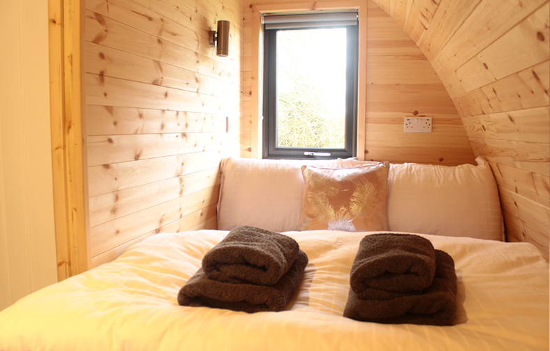 The bedroom of the holiday pod at mount hillary luxury camping site